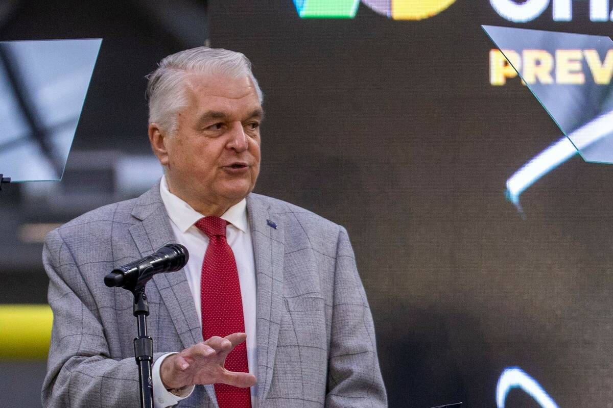 Governor Steve Sisolak speaks while flanked by Vegas Chamber President and CEO Mary Beth Sewald ...