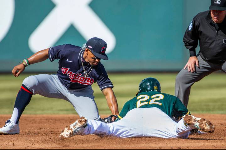 In this March 1, 2020, file photo, Cleveland Indians infielder Francisco Lindor (12) tags out ...