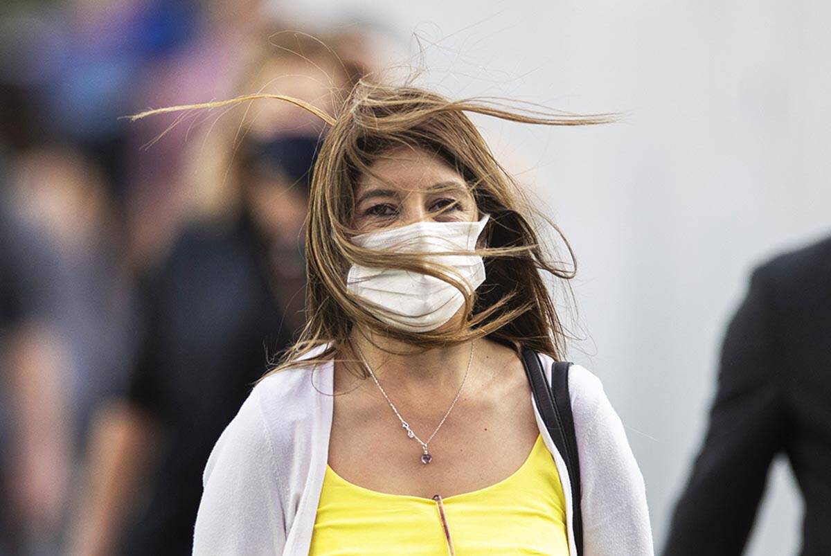 People brave high winds on the Strip on Monday, Oct. 11, 2021, in Las Vegas. A sunny sky with w ...