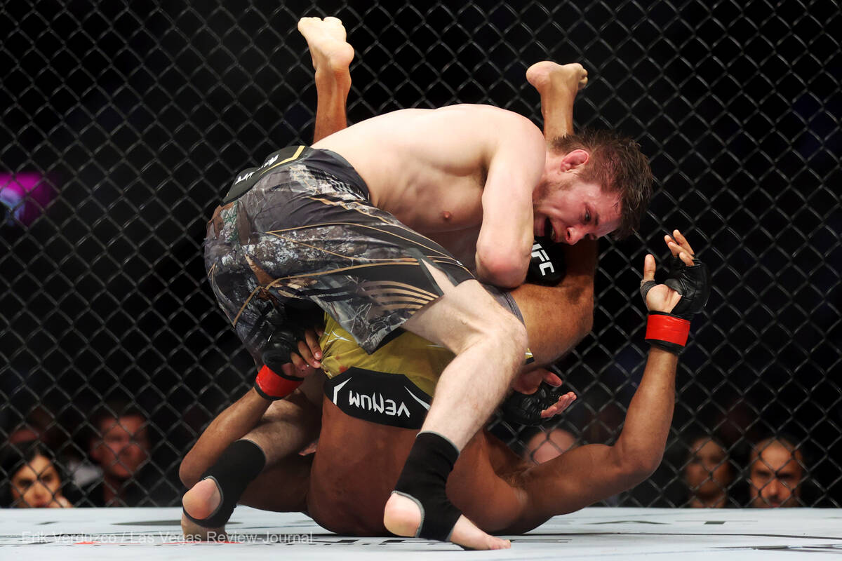 Bryce Mitchell, left, takes down Edson Barboza, in the third round of an UFC 272 featherweight ...