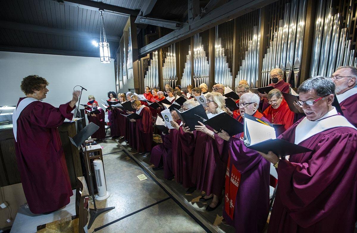 A choir from various churches is led in song by Kathi Colman, left, as the Rev. Elizabeth Bonfo ...