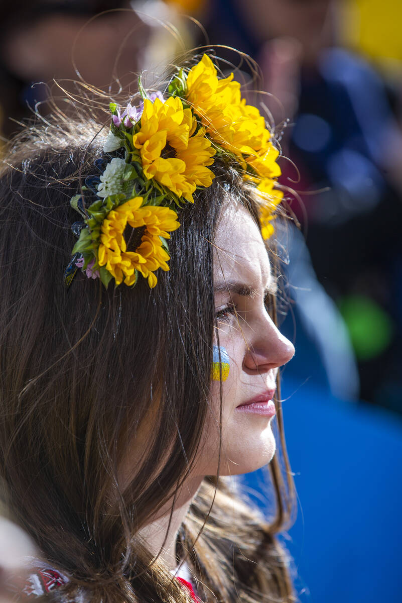 A young girl listens to one of many speeches during a Rally for Ukraine at City Hall on Saturda ...