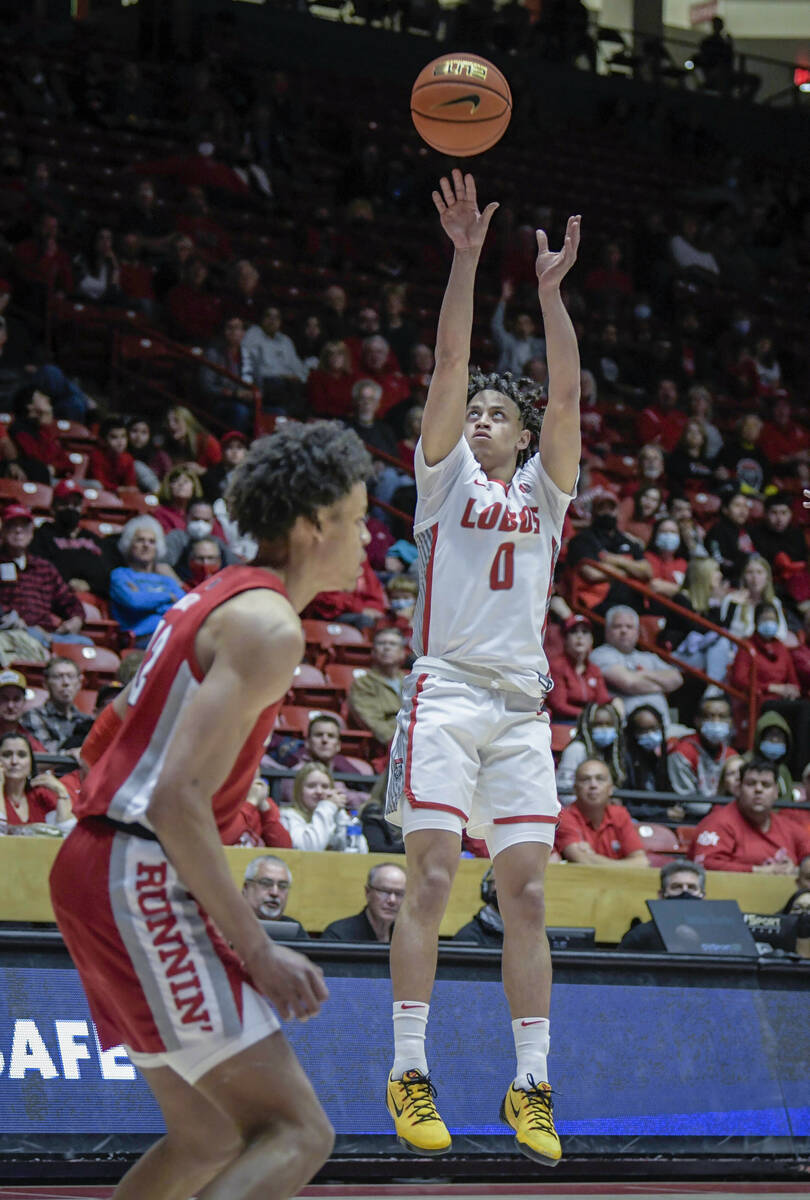 UNM's KJ Jenkins shoots a 3-pointer against UNLV during an NCAA college basketball game in Albu ...