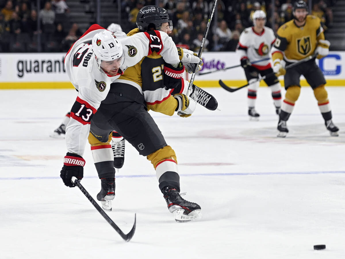Ottawa Senators left wing Zach Sanford (13) rolls over the top of Vegas Golden Knights defensem ...
