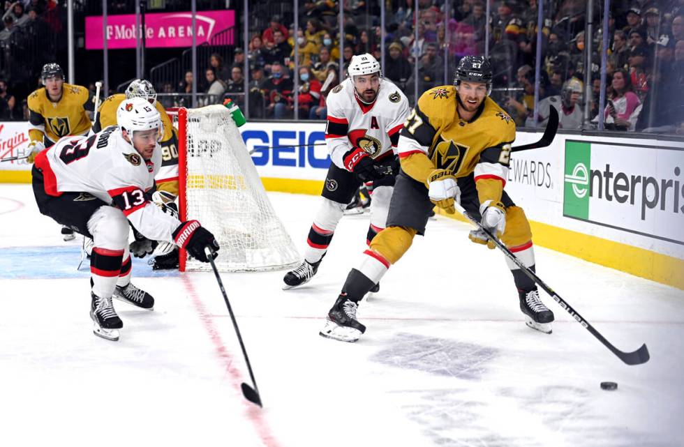 Ottawa Senators left wing Zach Sanford (13) goes to block a pass by Vegas Golden Knights defens ...