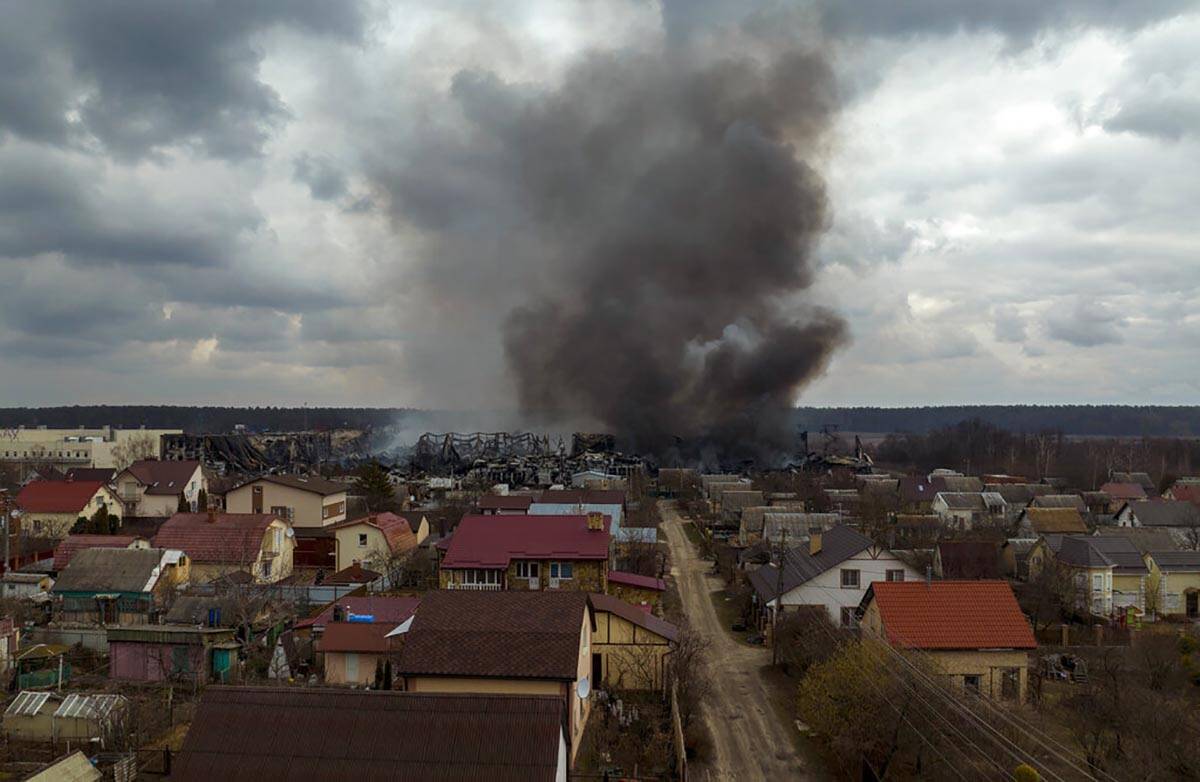 A factory and a store burn after being bombarded in Irpin, on the outskirts of Kyiv, Ukraine, S ...