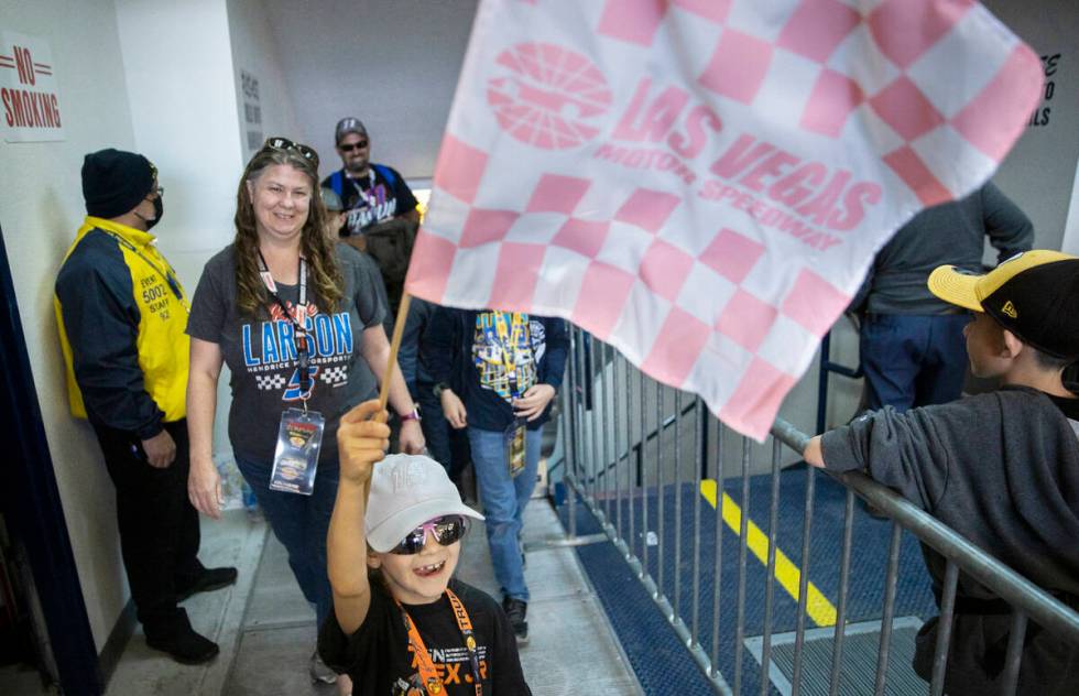 Katelynn Marino, from San Diego, Calif., waves her racing flag during the Pennzoil 400 NASCAR C ...