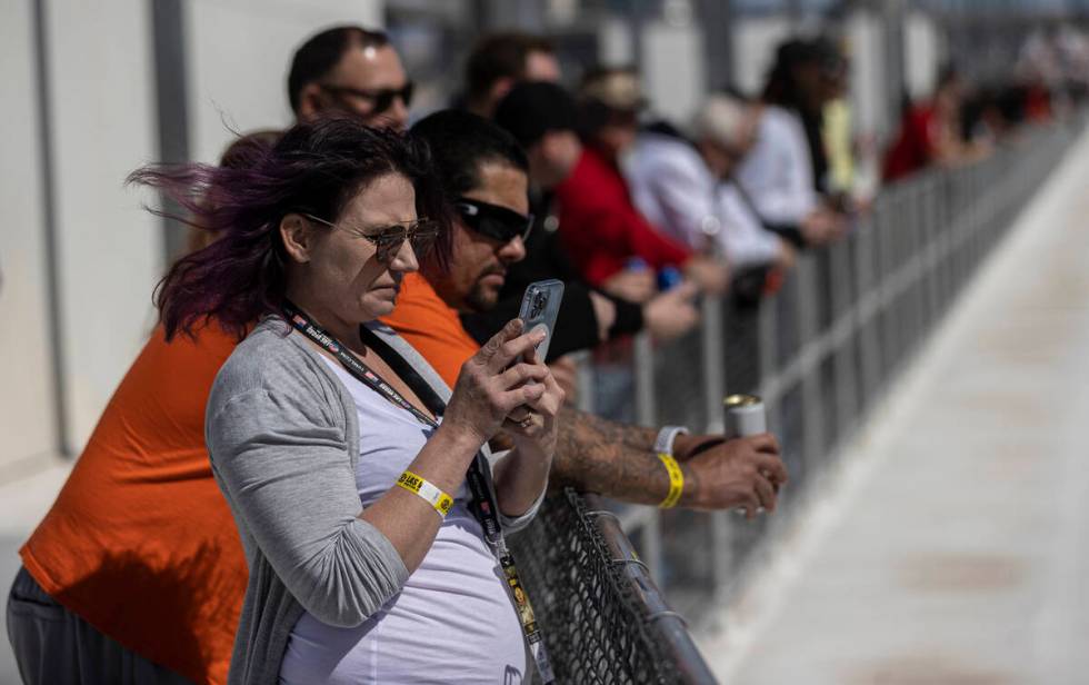 Fans watch the start of the Pennzoil 400 NASCAR Cup Series race on Sunday, March 6, 2022, at La ...