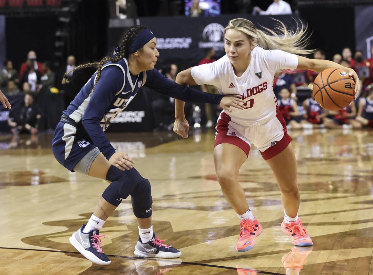 Fresno State Bulldogs guard Hanna Cavinder (0) drives against Utah State Aggies guard Shyla Lat ...