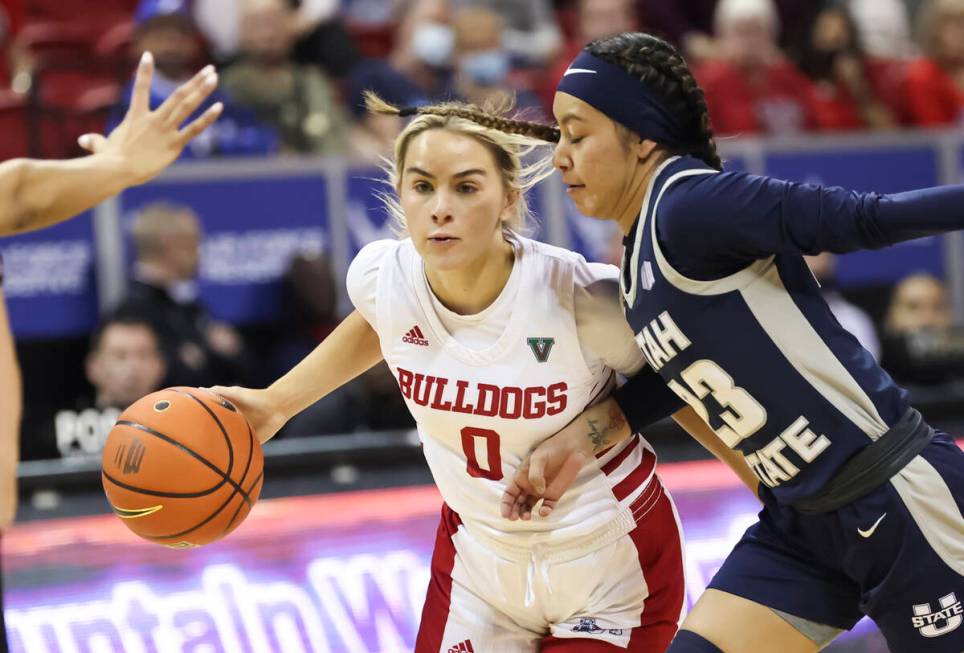 Utah State Aggies guard Faith Brantley (0) drives under pressure from Utah State Aggies guard S ...