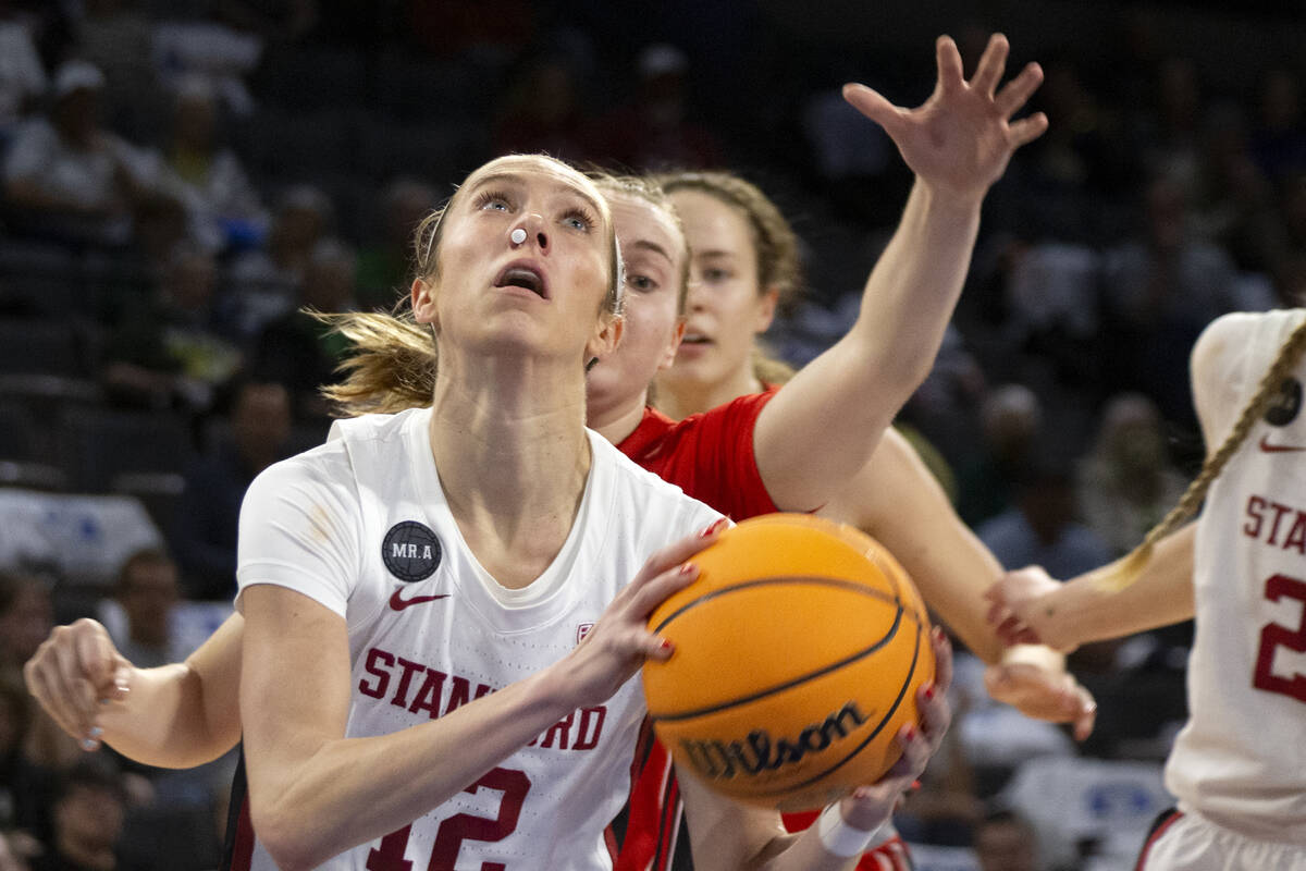 Stanford guard Lexie Hull (12) shoots while Utah guard Brynna Maxwell, behind, reaches to block ...