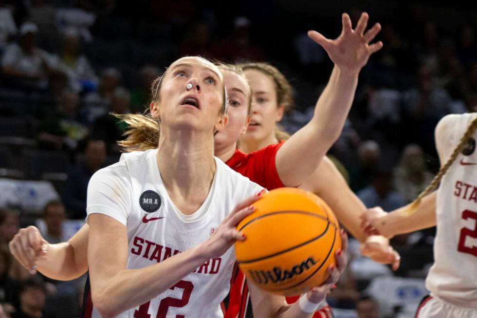 Stanford guard Lexie Hull (12) shoots while Utah guard Brynna Maxwell, behind, reaches to block ...