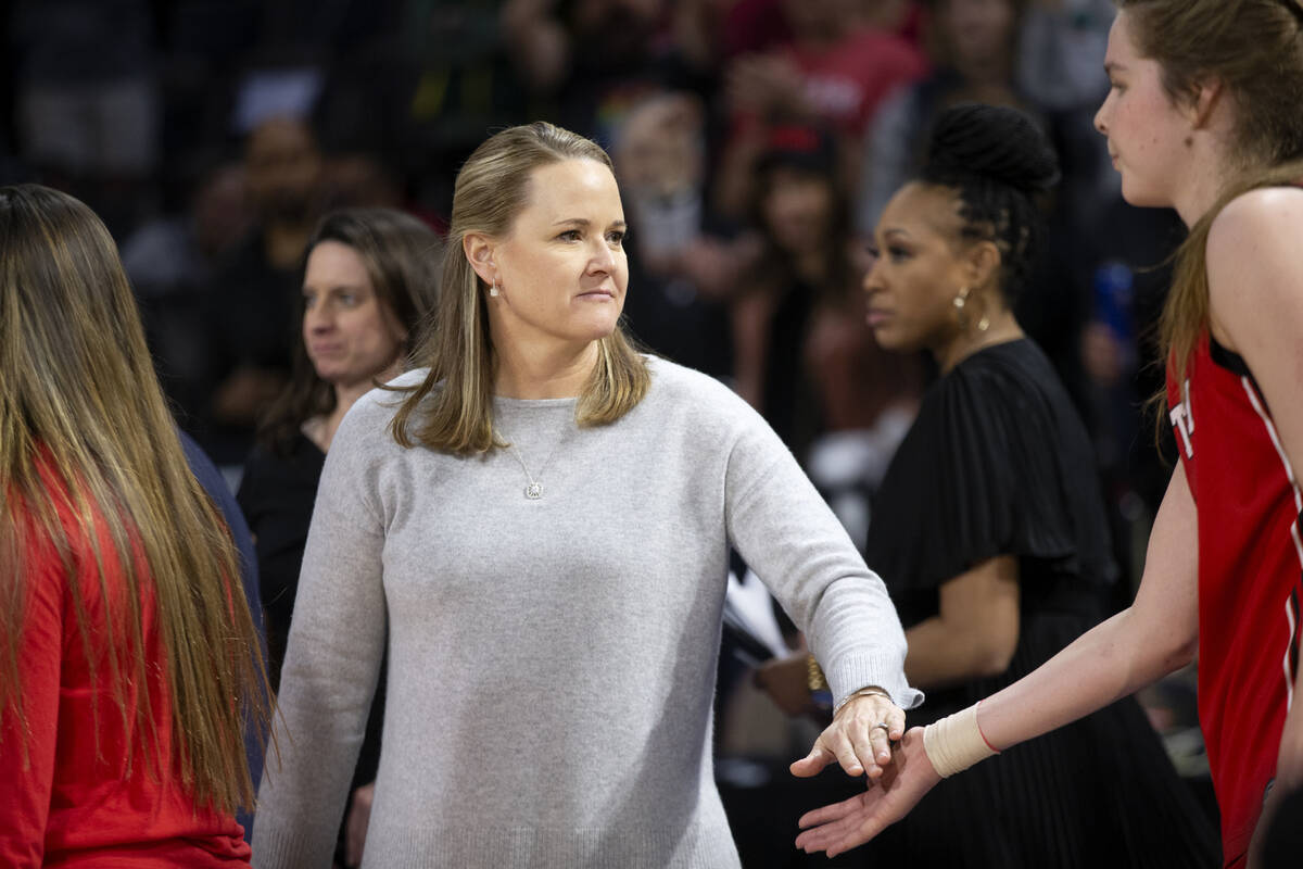 Utah head coach Lynne Roberts slaps hands with Utah forward Kelsey Rees, right, after their tea ...