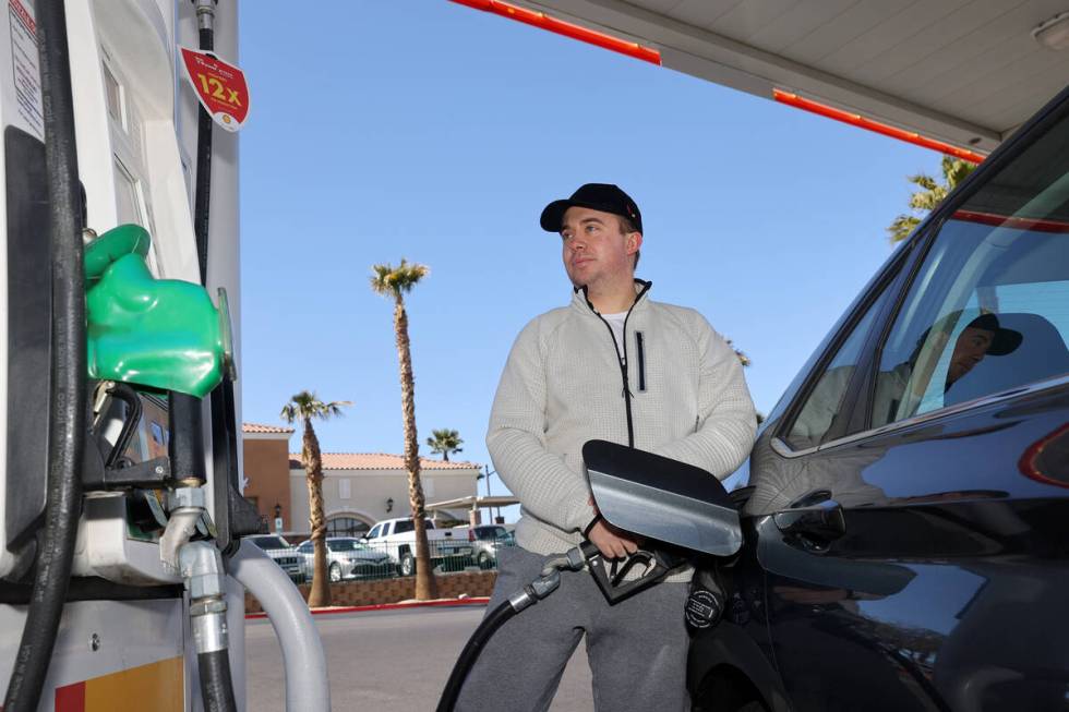 Keaton Johns of Las Vegas pumps gas at a station on Elkorn Road and Grand Montecito Parkway in ...