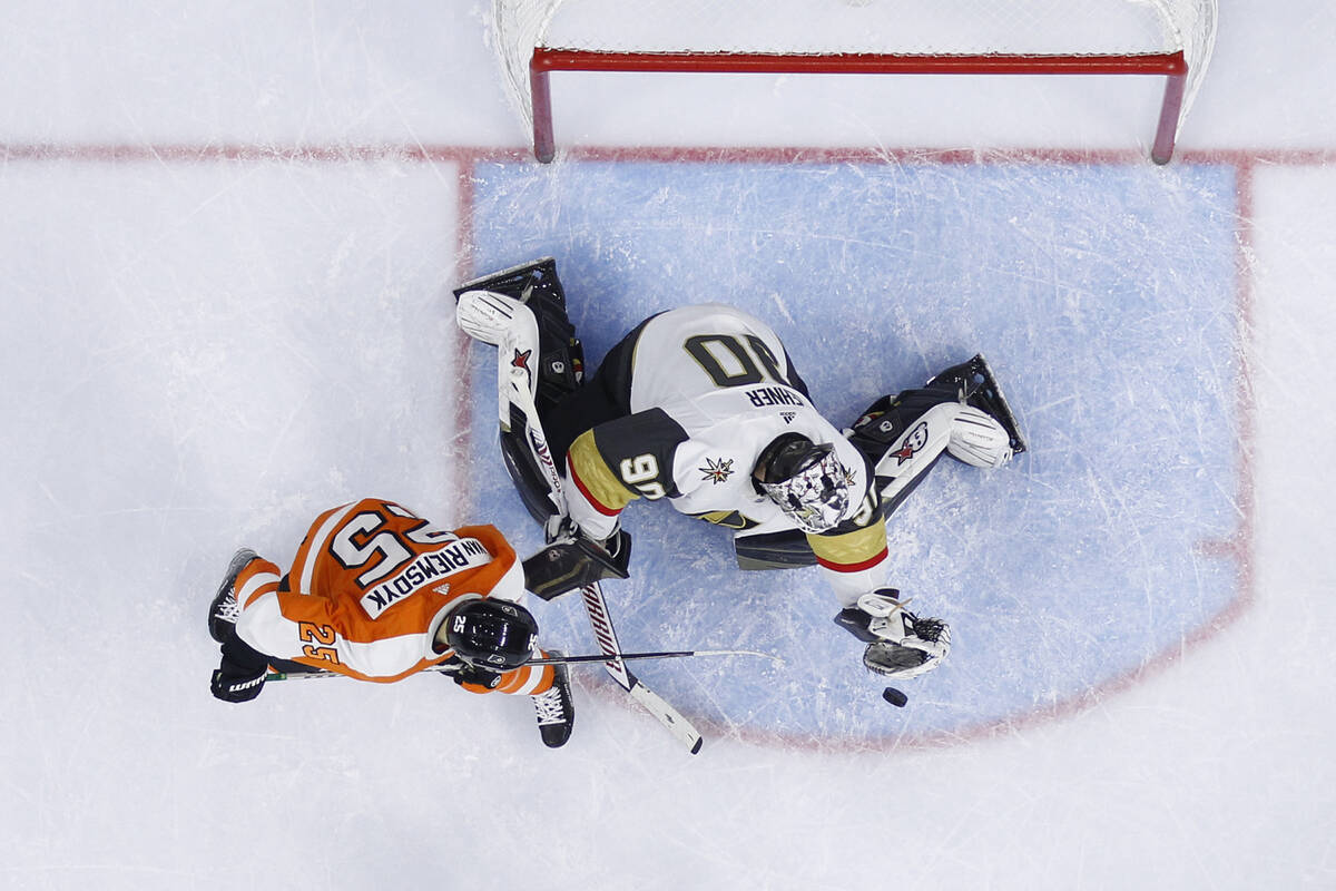 Vegas Golden Knights' Robin Lehner, right, blocks a shot as Philadelphia Flyers' James van Riem ...