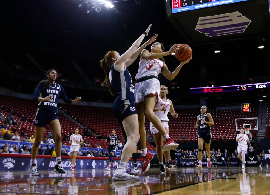 UNLV Lady Rebels guard Kiara Jackson (3) lays up the ball against Utah State Aggies guard Emmie ...