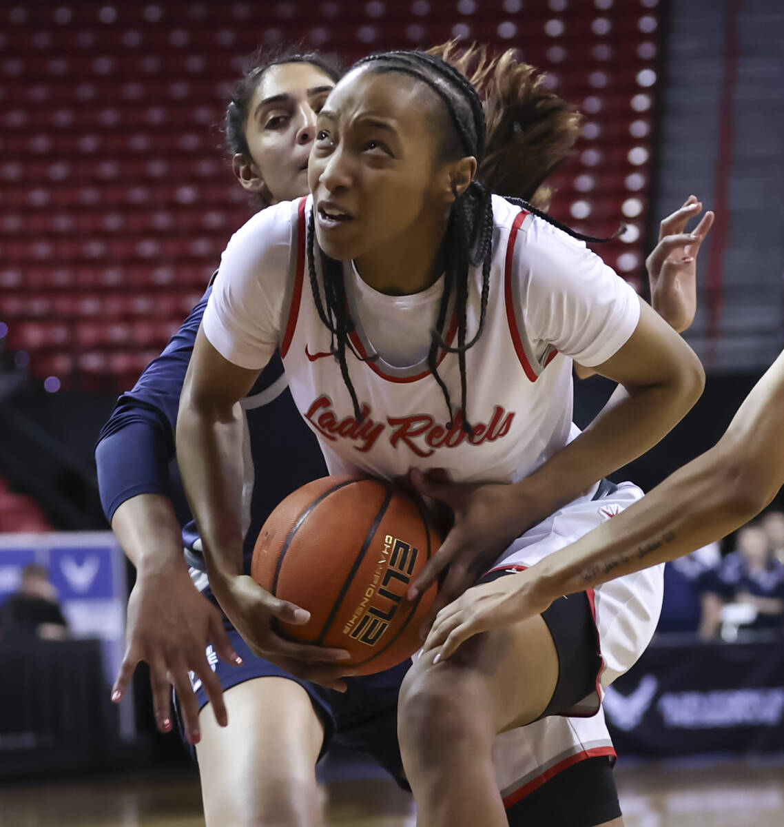 UNLV Lady Rebels guard Justice Ethridge (11) drives to the basket between Utah State Aggies gua ...