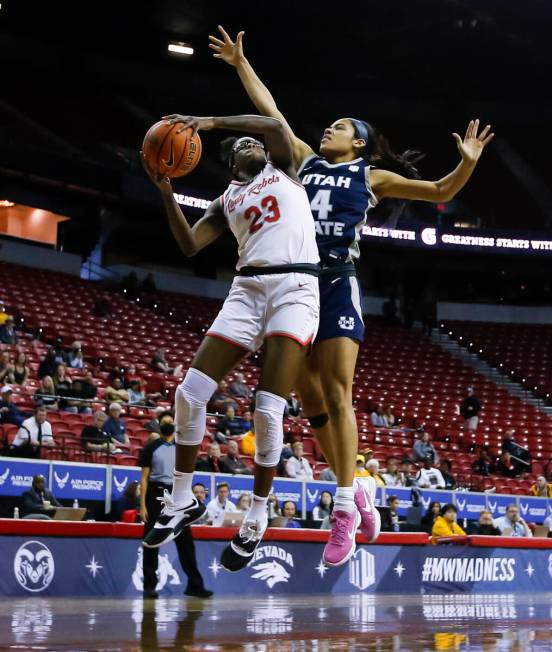 UNLV Lady Rebels center Desi-Rae Young (23) shoots under pressure from Utah State Aggies guard ...