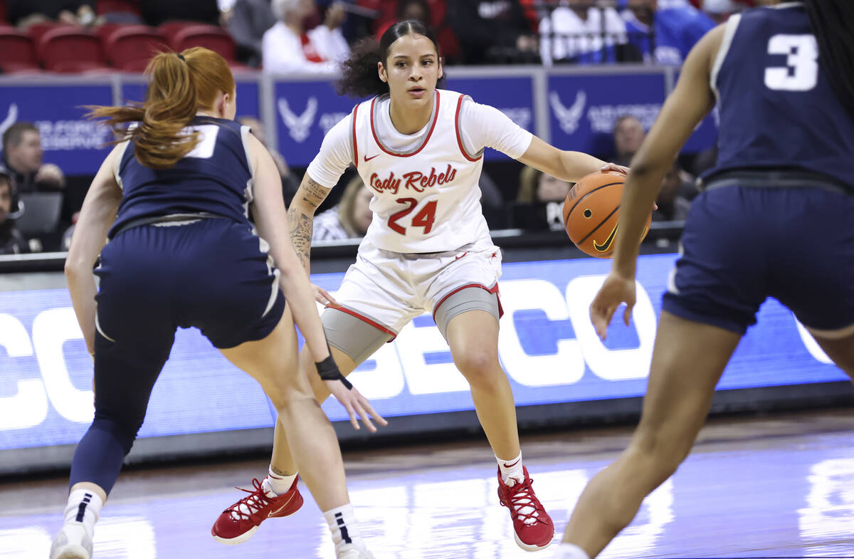 UNLV Lady Rebels guard Essence Booker (24) brings the ball up court under pressure from Utah St ...