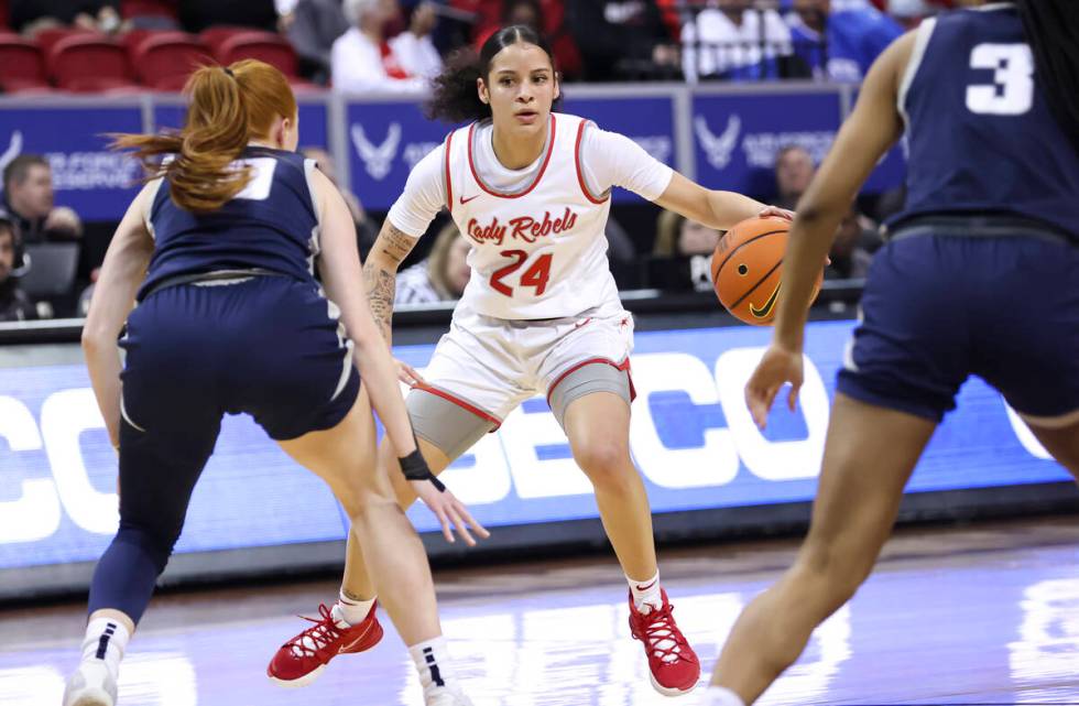 UNLV Lady Rebels guard Essence Booker (24) brings the ball up court under pressure from Utah St ...