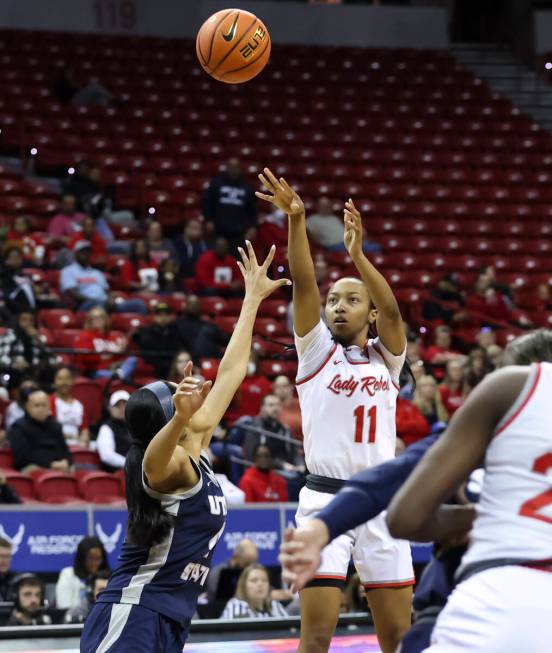 UNLV Lady Rebels guard Justice Ethridge (11) shoots over Utah State Aggies guard E'Lease Staffo ...