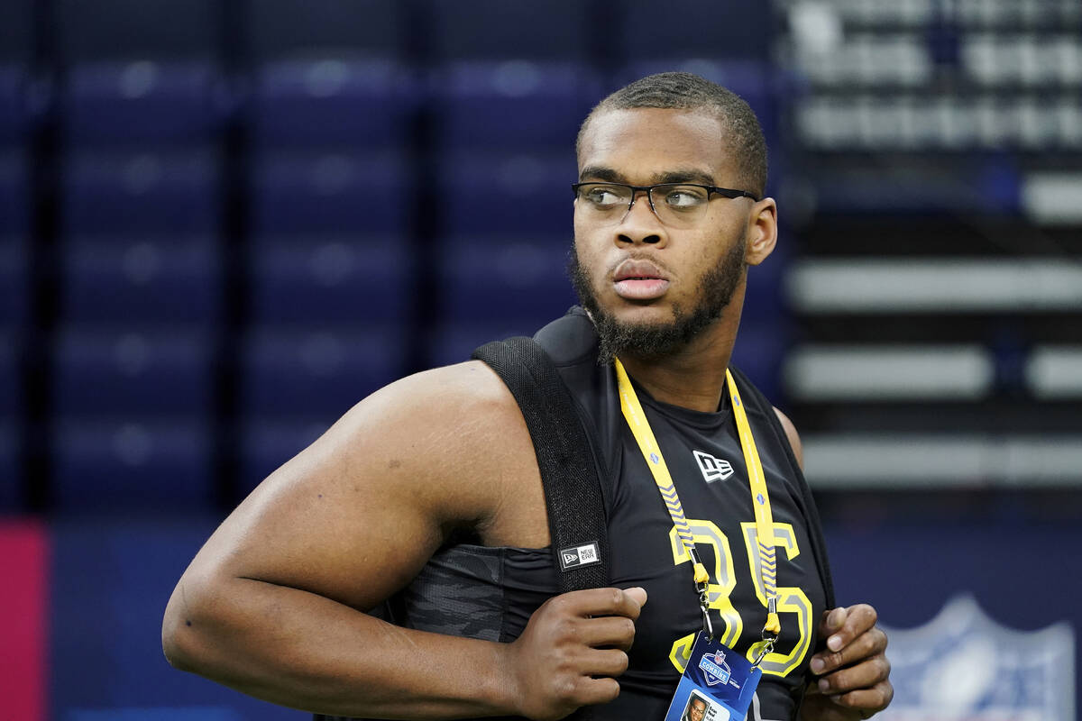 Alabama offensive lineman Evan Neal (35) looks on from the sideline at the NFL football scoutin ...