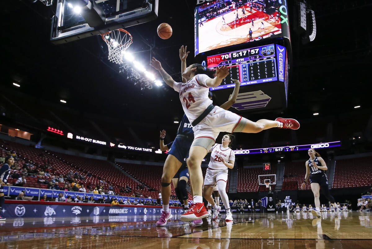 UNLV Lady Rebels guard Essence Booker (24) drives for a layup against the Utah State Aggies dur ...