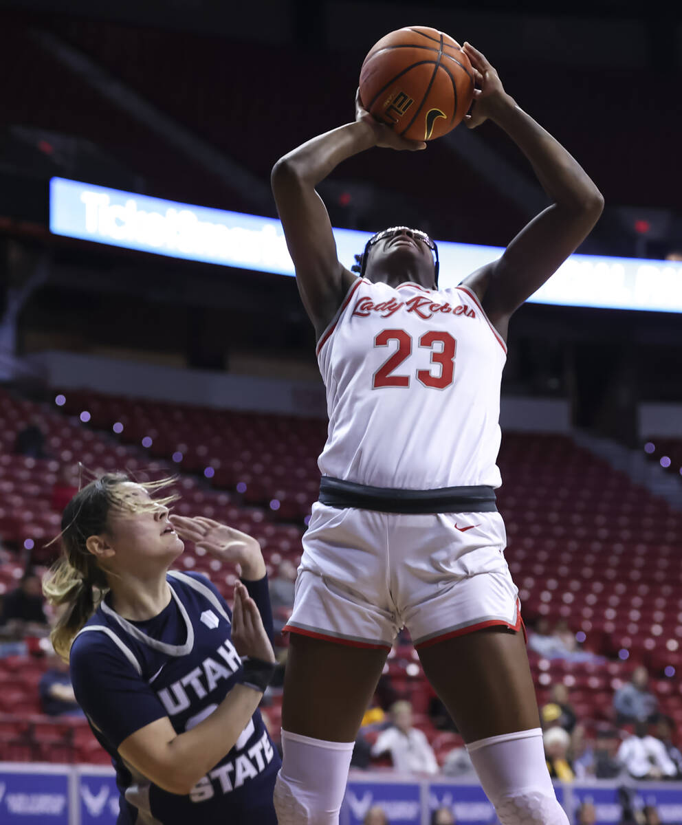 UNLV Lady Rebels center Desi-Rae Young (23) shoots in front of Utah State Aggies guard Adryana ...