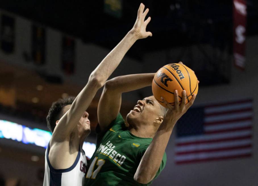 San Francisco Dons forward Patrick Tape (11) is fouled on the way to the rim by Gonzaga Bulldog ...