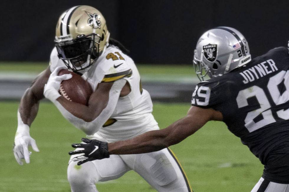 New Orleans Saints running back Alvin Kamara (41) cuts up field past Las Vegas Raiders free saf ...