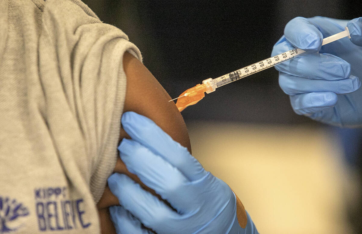 Medical personnel vaccinate students at a school in New Orleans on Tuesday, Jan. 25, 2022. Rese ...