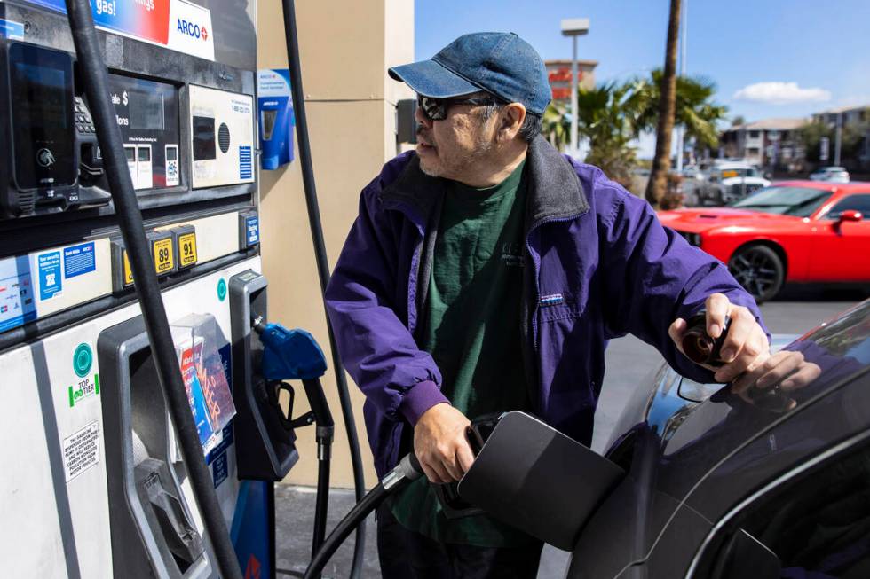 Ken Yamaguchi of Las Vegas pumps gas at Arco on Charleston Boulevard on Monday, March 7, 2022, ...