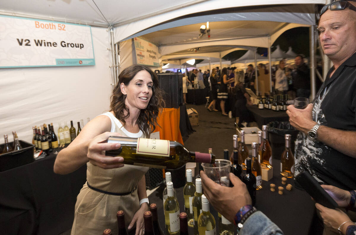 Guest sample wines at the V2 Wine Group booth during the 44th Annual UNLVino fundraiser at the ...
