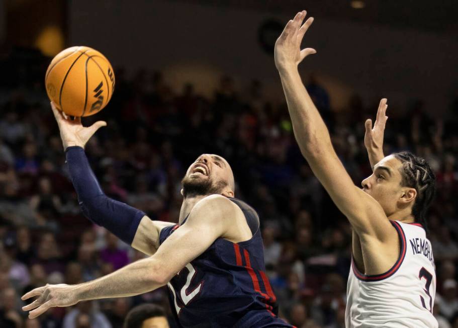 St. Mary's Gaels guard Tommy Kuhse (12) shoots over Gonzaga Bulldogs guard Andrew Nembhard (3) ...