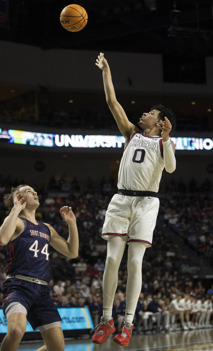 Gonzaga Bulldogs guard Julian Strawther (0) shoots over St. Mary's Gaels guard Alex Ducas (44) ...