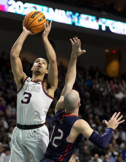 Gonzaga Bulldogs guard Andrew Nembhard (3) drives past St. Mary's Gaels guard Tommy Kuhse (12) ...