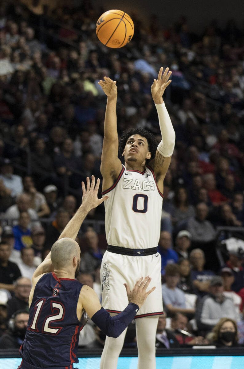 Gonzaga Bulldogs guard Julian Strawther (0) shoots over St. Mary's Gaels guard Tommy Kuhse (12) ...