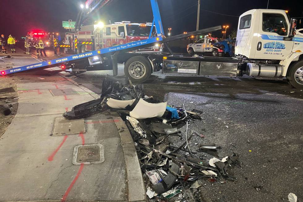 Authorities get set to tow a vehicle involved a six-car crash at the scene of a fatal crash on ...