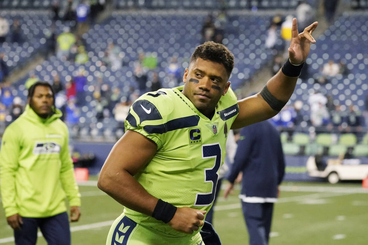 Seattle Seahawks quarterback Russell Wilson waves to fans as he leaves the field after an NFL g ...