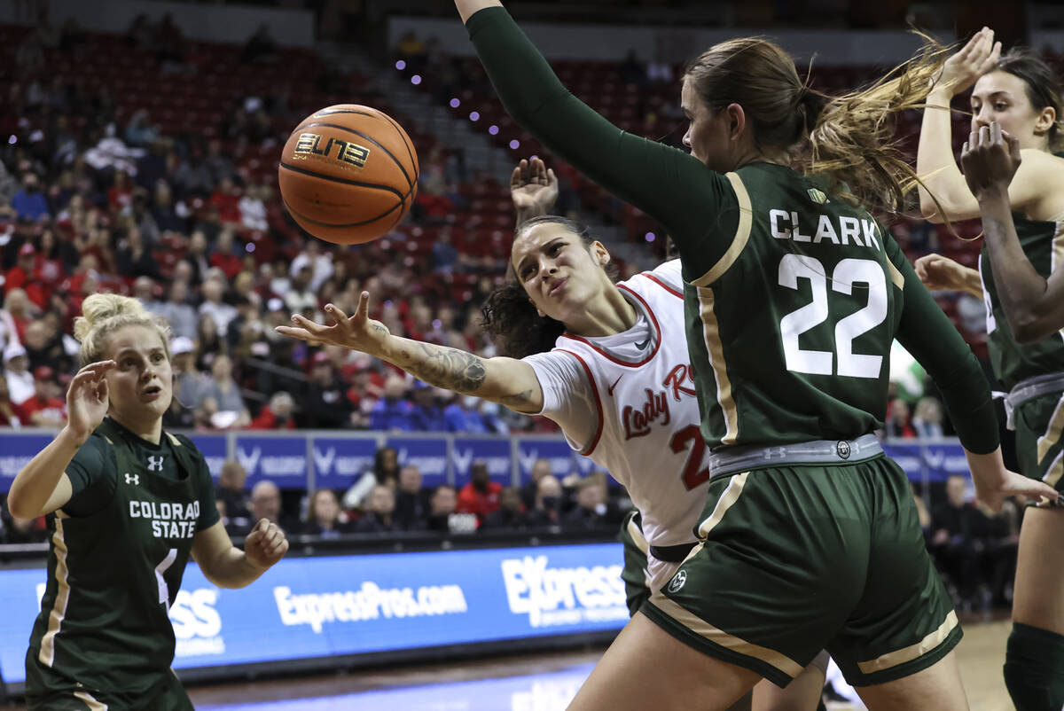 UNLV Lady Rebels guard Essence Booker (24) reaches out to redirect the ball to a teammate under ...