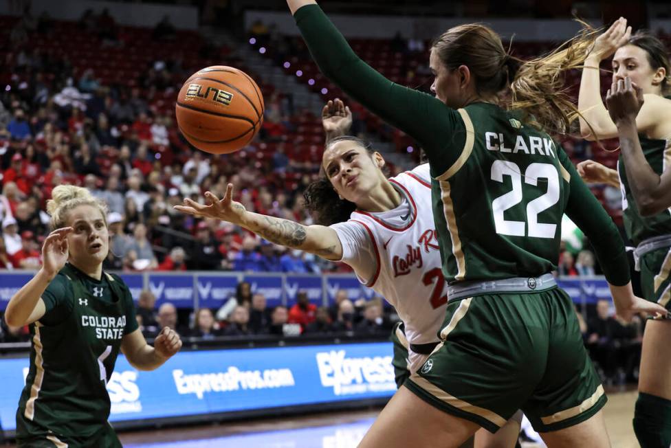 UNLV Lady Rebels guard Essence Booker (24) reaches out to redirect the ball to a teammate under ...