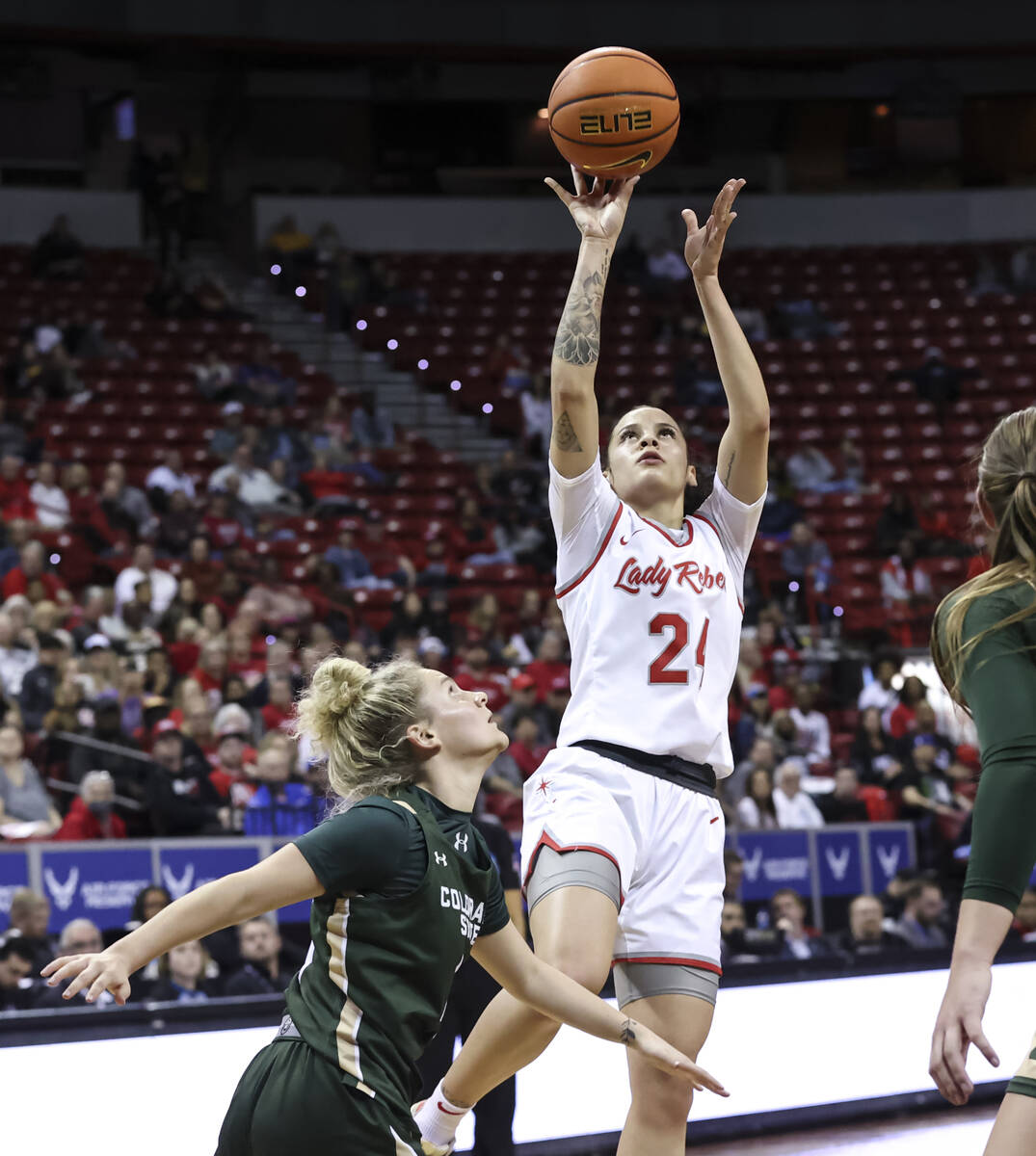 UNLV Lady Rebels guard Essence Booker (24) shoots over Colorado State Rams guard McKenna Hofsch ...