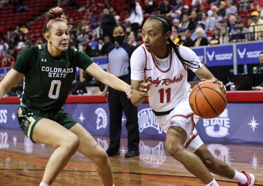 UNLV Lady Rebels guard Justice Ethridge (11) drives to the basket against Colorado State Rams f ...