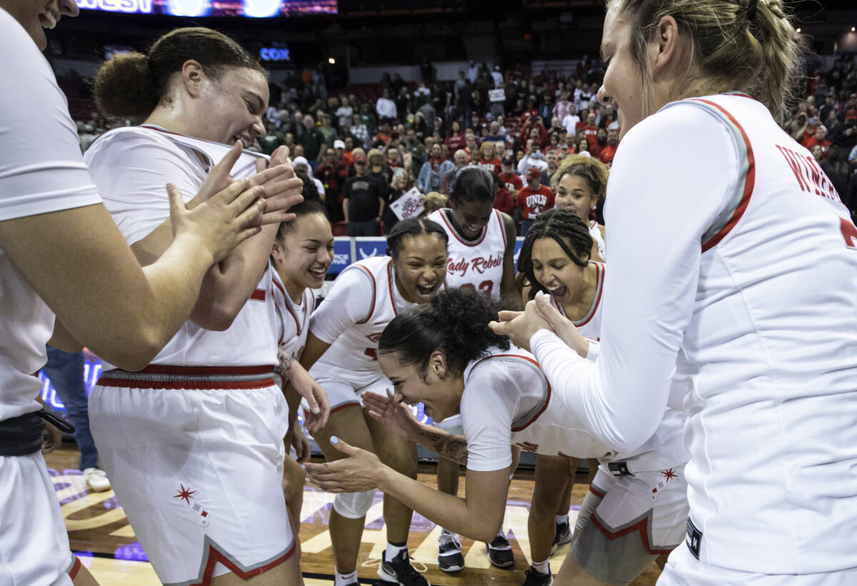 The UNLV Lady Rebels celebrate after defeating the Colorado State Rams 75-65 to win the Mountai ...