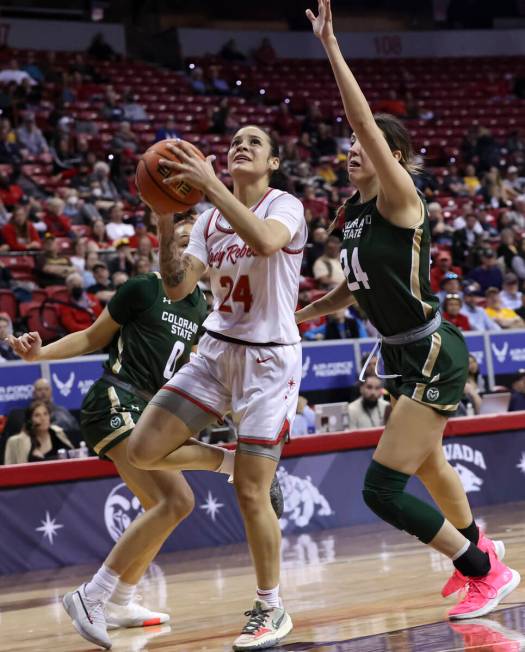 UNLV Lady Rebels guard Essence Booker (24) lays up the ball in front of Colorado State Rams gua ...