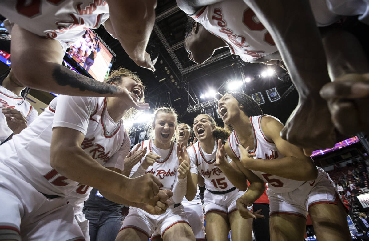 The UNLV Lady Rebels celebrate after defeating the Colorado State Rams 75-65 to win the Mountai ...