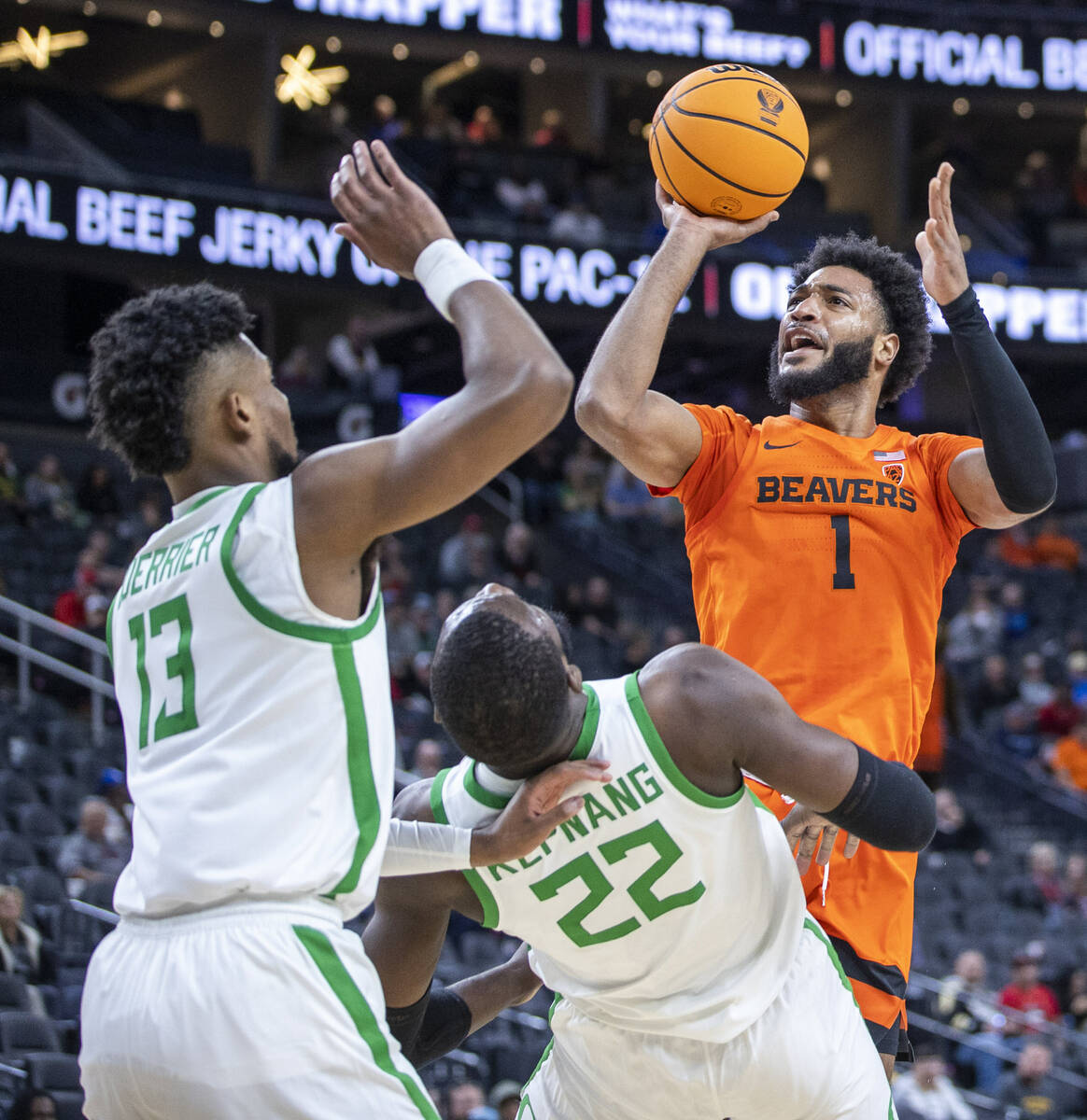 Oregon State Beavers forward Maurice Calloo (1) looks to get off a shot after colliding with Or ...