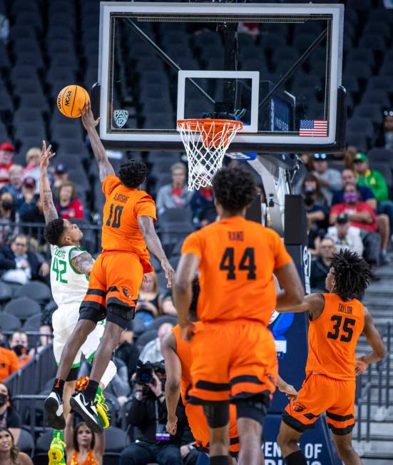 Oregon Ducks guard Jacob Young (42) has a shot blocked by Oregon State Beavers forward Warith A ...