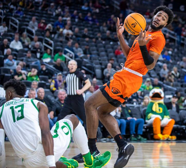 Oregon State Beavers forward Maurice Calloo (1) loses the ball after charging into Oregon Ducks ...