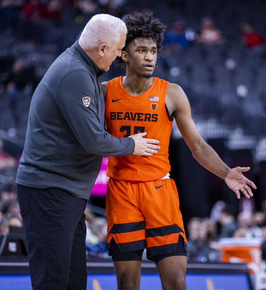 Oregon State Beavers head coach Wayne Tinkle counsels forward Glenn Taylor Jr. (35) as they kee ...